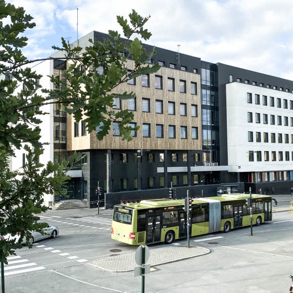 A bus parked in front of a building