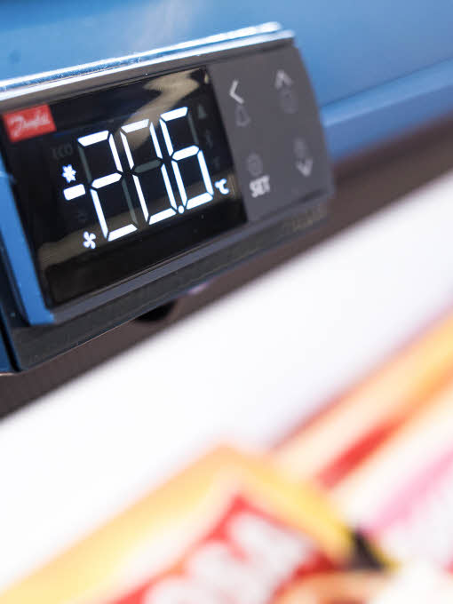 A digital thermometer on a storefreezer